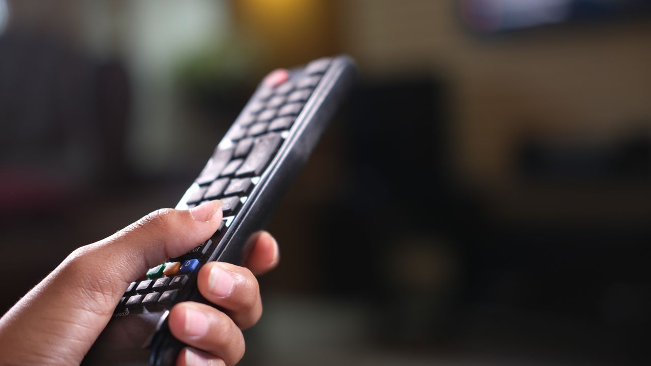Televizyon kumandası tutan el